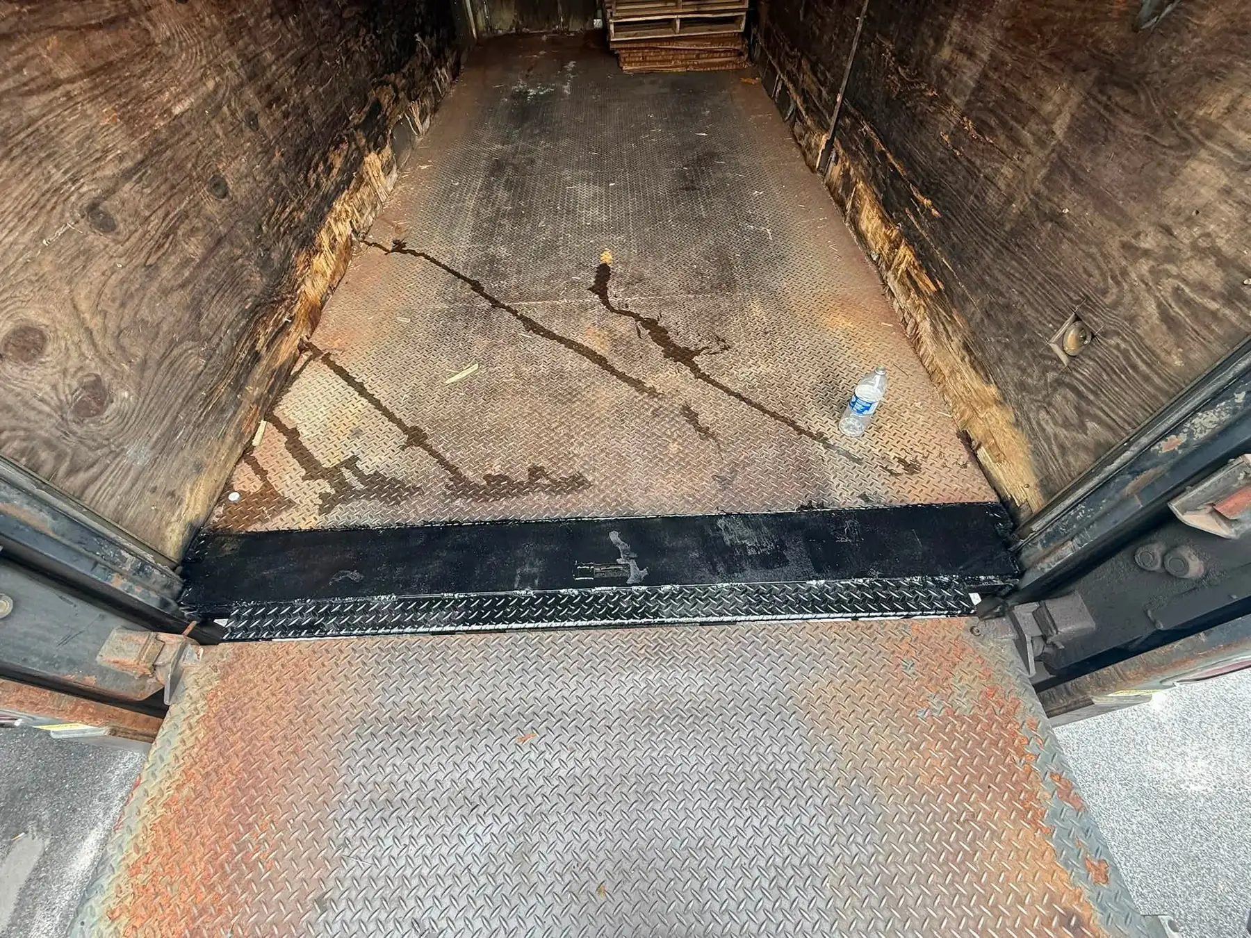 The same box truck doorway after a new steel diamond plate threshold was fitted and welded in flush