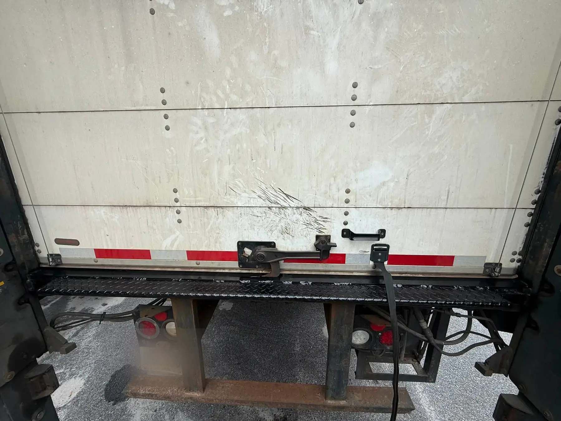 Rear exterior of a box truck after a new threshold plate was fitted, seen from behind with the door closed