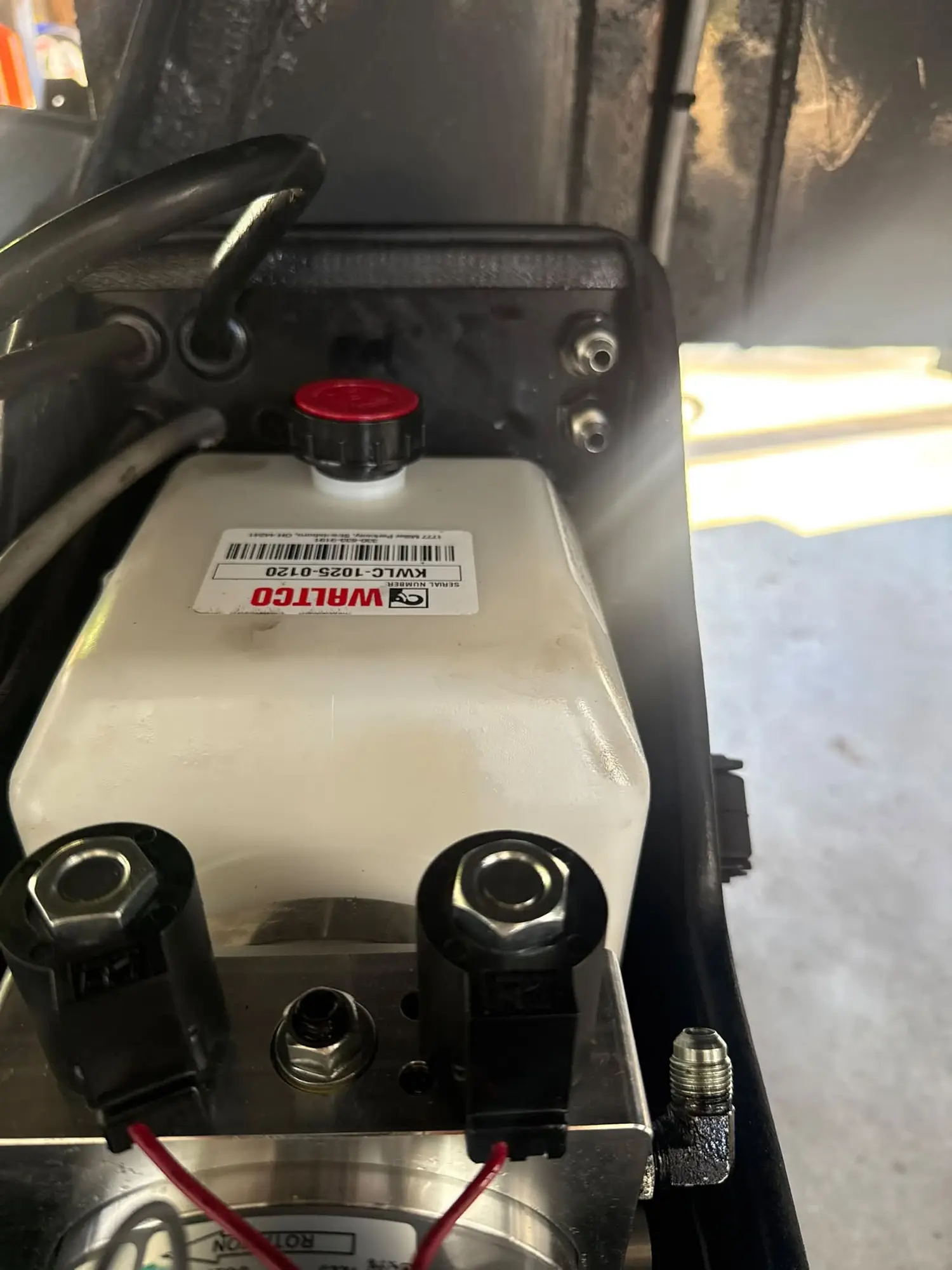 A new Waltco hydraulic pump motor assembly with reservoir and valve block fitted to a liftgate